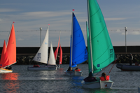 Light Blue, Green, Red, Orange and Purple Access 303 Dinghies sailing in Carrickfergus Harbour