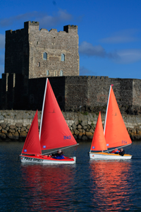 Red and Orange Access 303 Dinghies Sailing in Carrickfergus Harbour