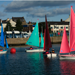 Light Blue, Green, Red and Pink Access 303 Dinghies sailing in Carrickfergus Harbour